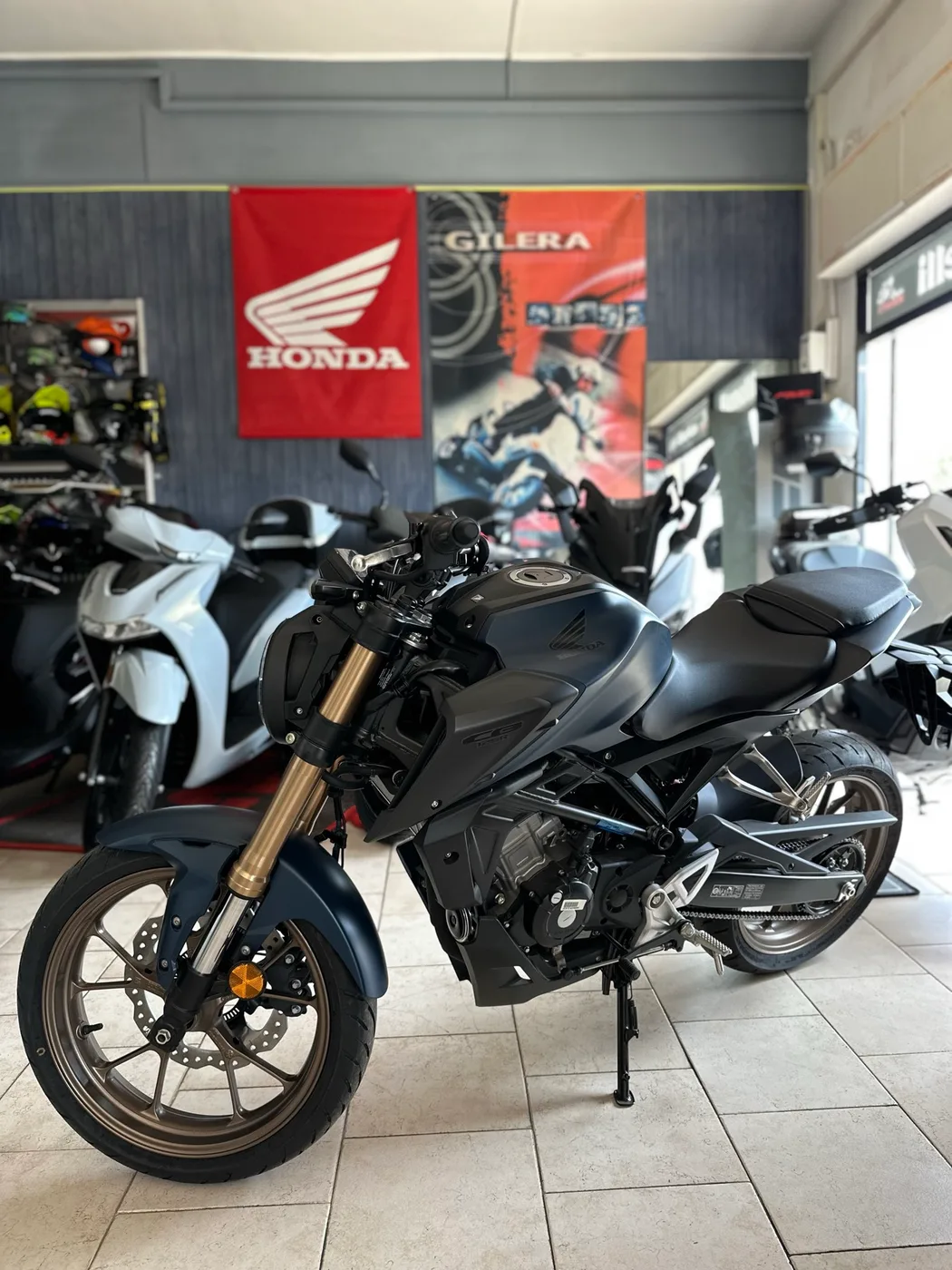 Moto stradale nera, vista di tre quarti nel negozio.